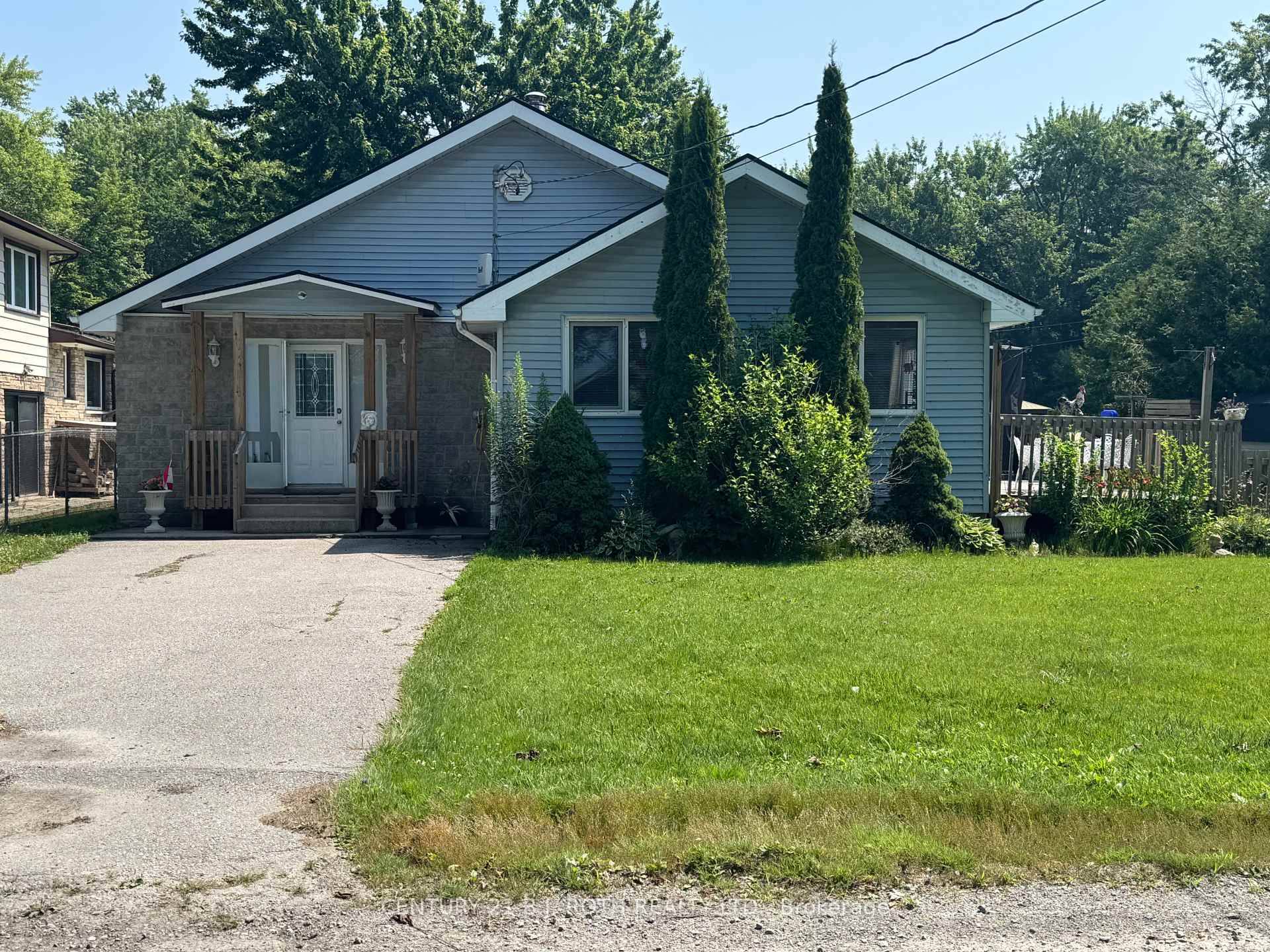 Bright Open Concept Three Bedroom Bungalow Featuring Large 100X220 Ft Lot, Wood Burning Stove, Propane Heating and AC, Large Eat In Kitchen with Walkout to Deck Overlooking Fenced Yard, Double ...
