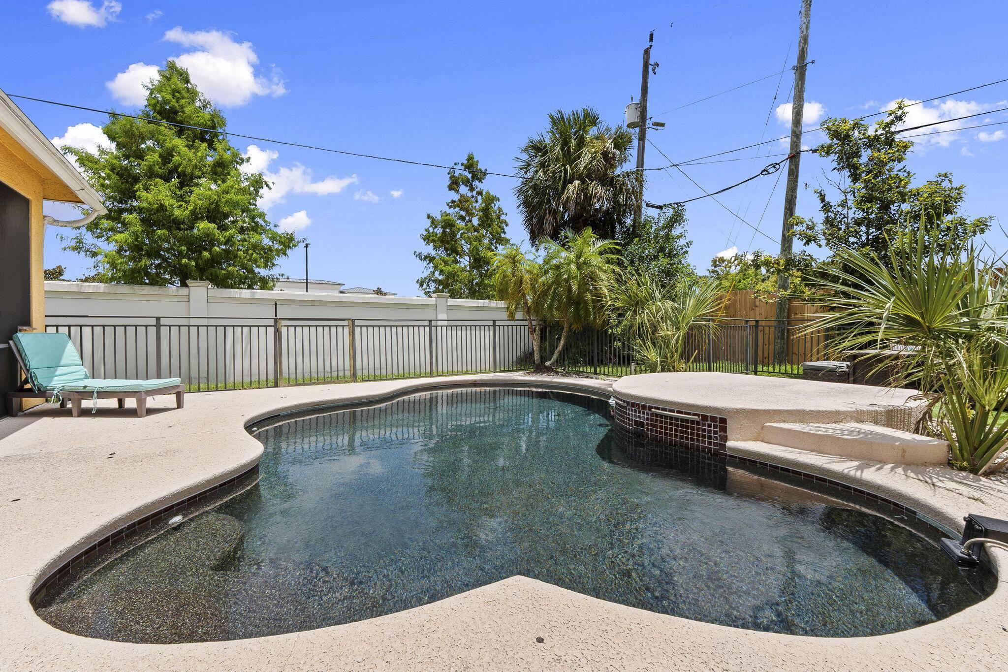 Move in ready former builder's model located in the heart of Port Saint Lucie, offering exceptional upgrades, no HOA restrictions, and a resort style outdoor living space or Airbnb income ...