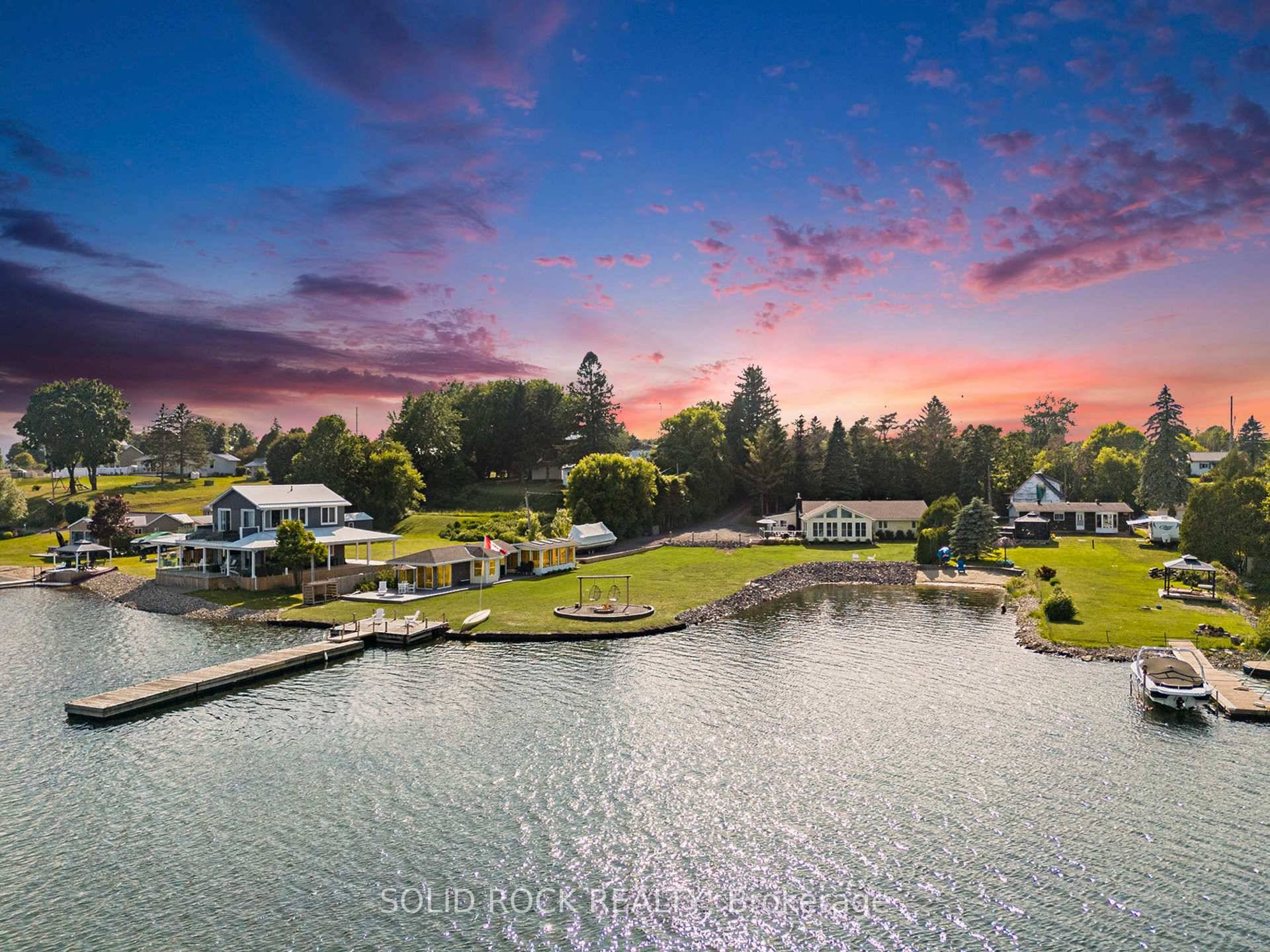 Step into refined waterfront living with this completely renovated 3 bedroom bungalow, blending cozy cottage charm with modern luxury.