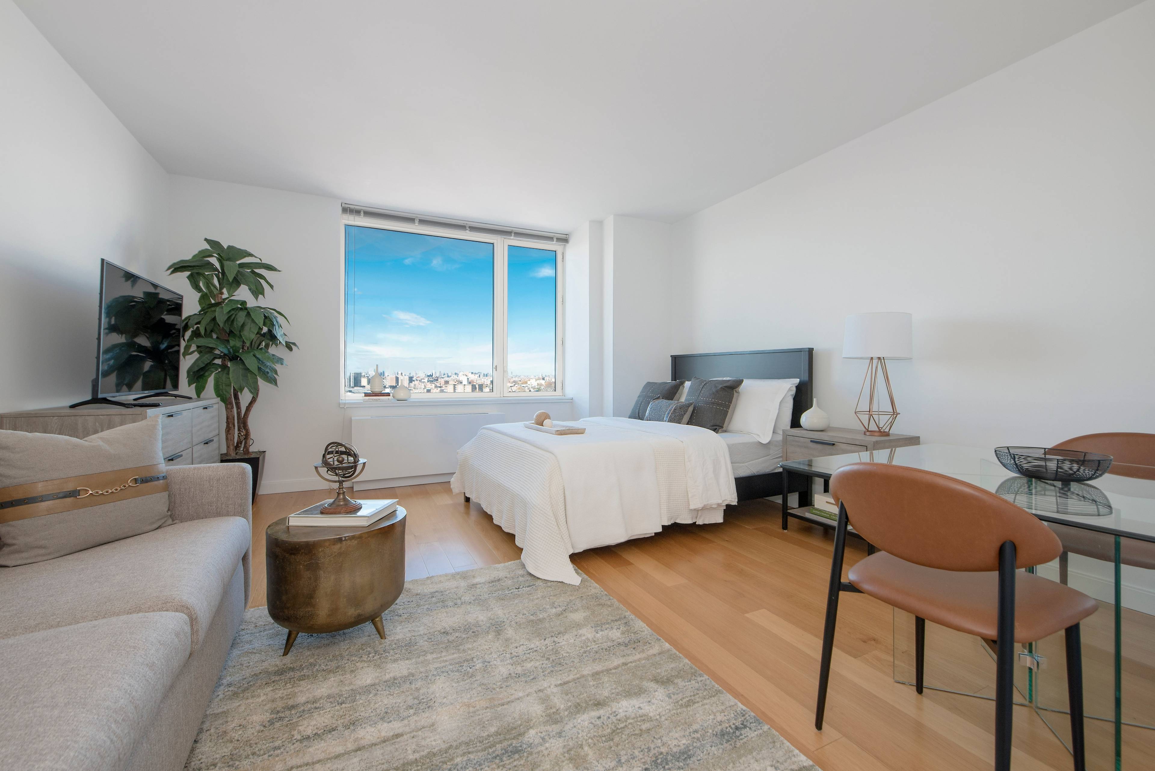 SCHEDULE A TOUR TODAY. Bright studio apartment with over sized windows featuring NYC skyline views.