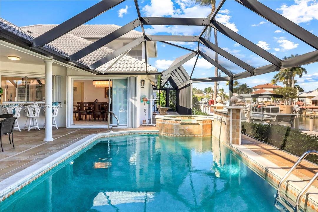 Experience premier waterfront living with this distinguished 5 bedroom, 4 bath residence, strategically situated on nearly half an acre with direct Gulf of Mexico access.