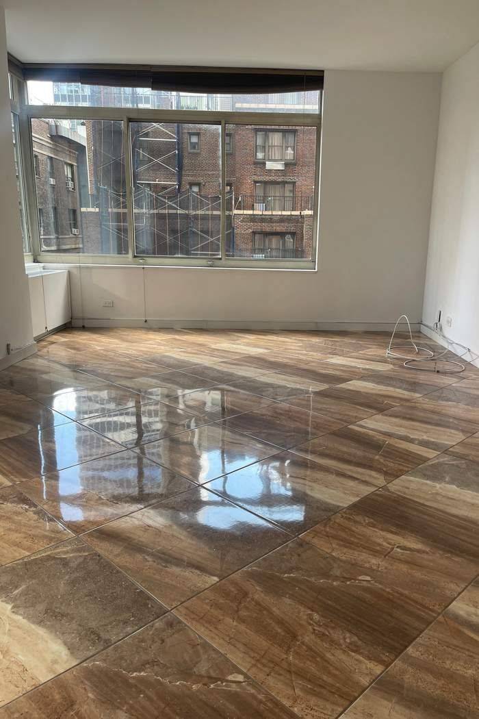 Welcome to a sun drenched corner residence with open southeast exposures and partial East River views.