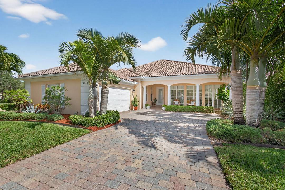 Enjoy the spectacular long lake and pool view located on a premium professionally landscaped lot in Palm Beach Gardens in the the Carlton Oaks community.