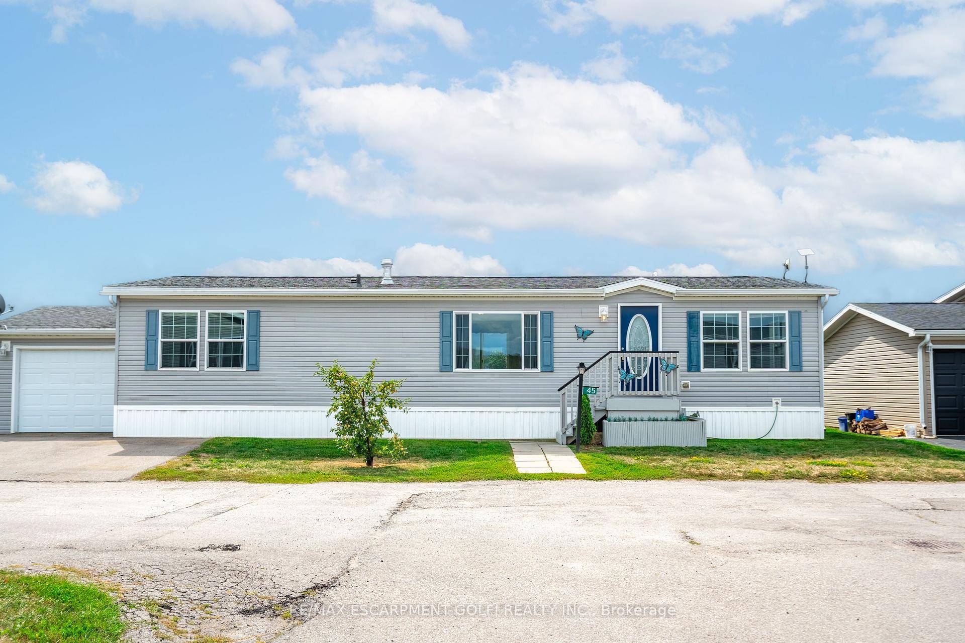 This beautifully landscaped bungalow boasts stunning curb appeal and direct waterfront views of Lake Erie.
