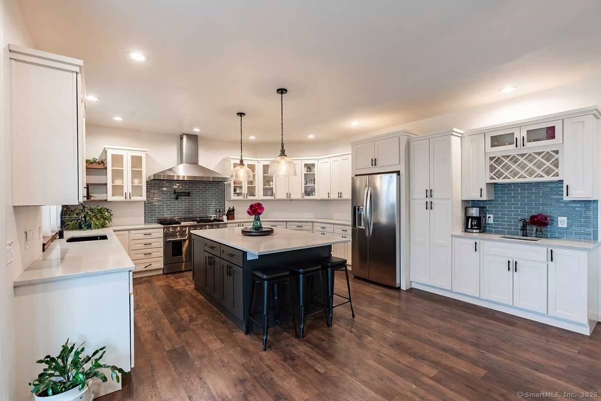 Setback on a wooded lot, this 2, 800 square foot modern farmhouse exudes timeless charm with contemporary elegance.