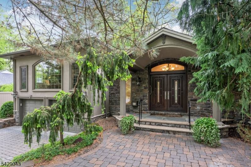 Professionally landscaped with beautiful uplighting and exceptional backyard privacy, this masterfully expanded high end ranch offers an open floor plan ideal for everyday living and entertaining.