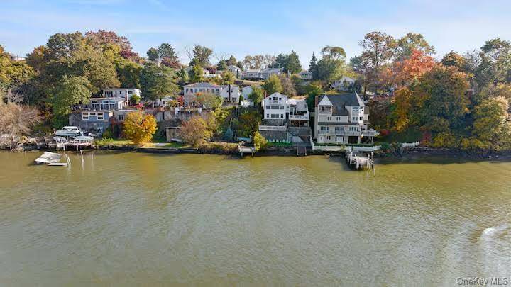 Wake up to panoramic Hudson River views in this stunning Verplanck waterfront home with its own dock access.