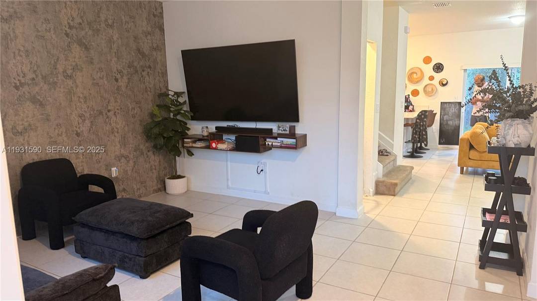 The home features a bright open concept design with a well appointed gourmet kitchen complete with stainless steel appliances, quartz countertops, and ample cabinet space.