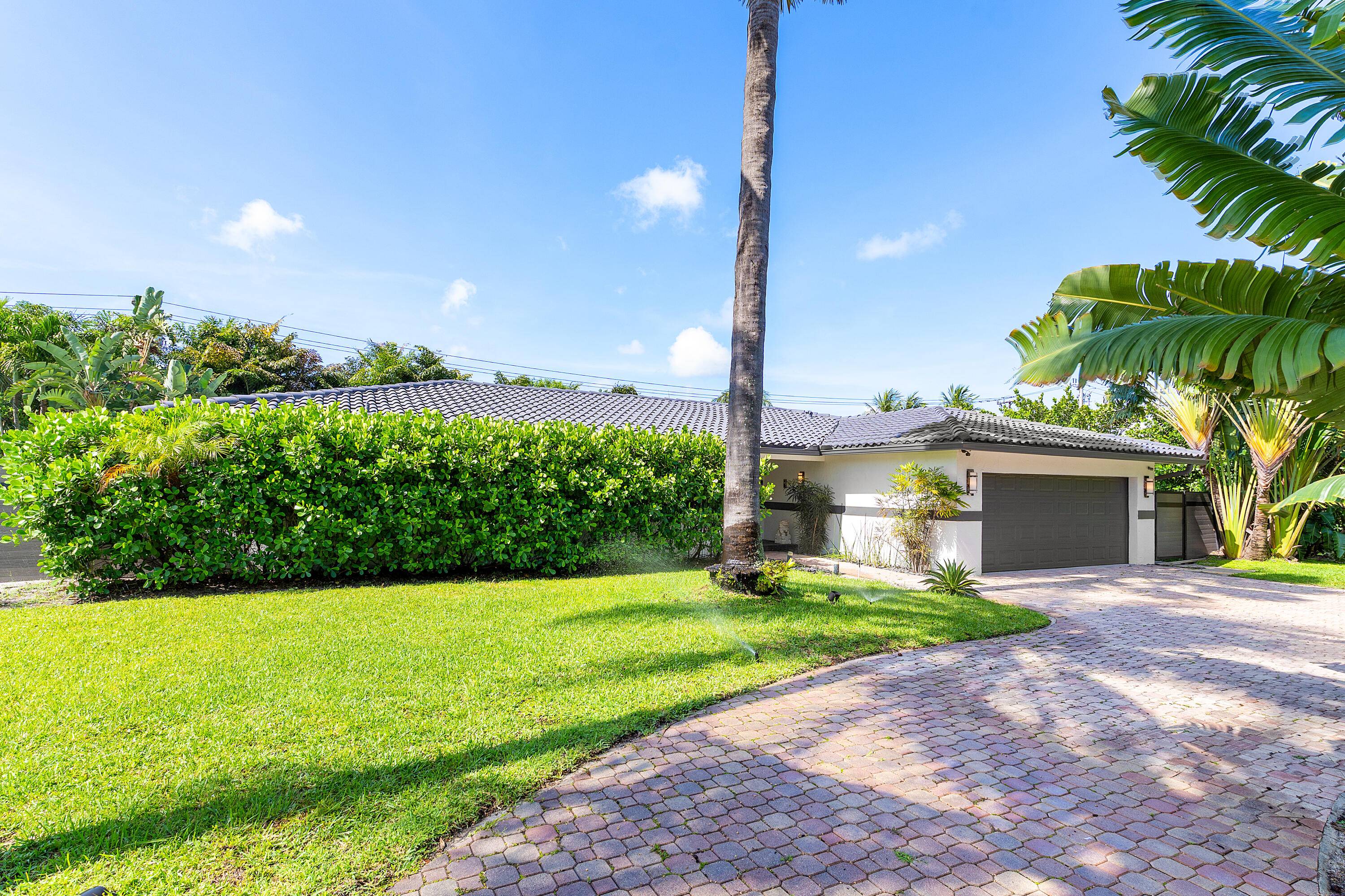 This Stunning 4 bedroom residence is situated on an oversized 15, 000 Sqft lot in the highly desirable Palm Beach Farms neighborhood.