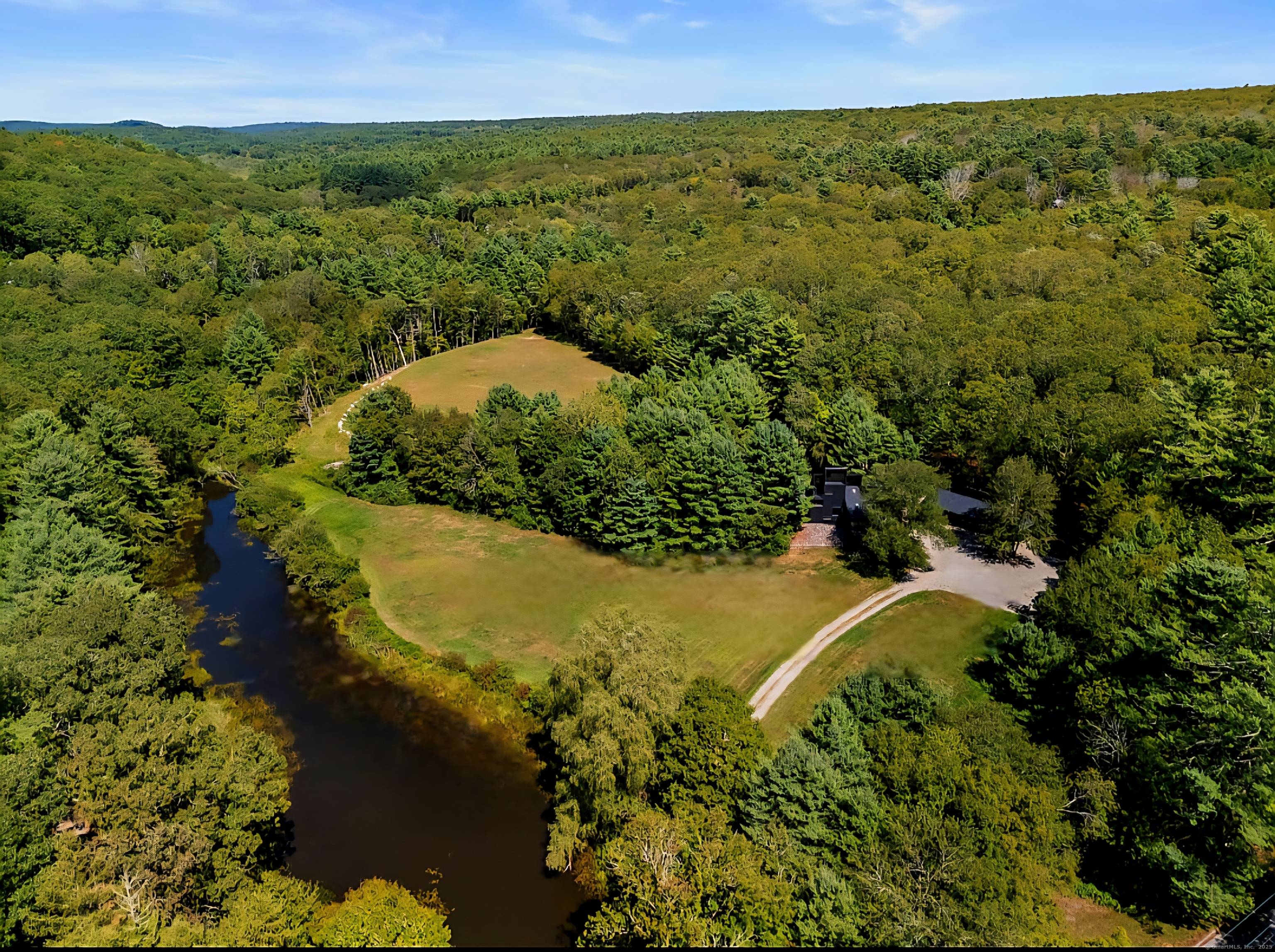 The escape begins the moment you turn onto the perfectly etched country drive, where a winding dirt road leads through the meadow revealing a distinctive contemporary home thoughtfully remodeled to ...