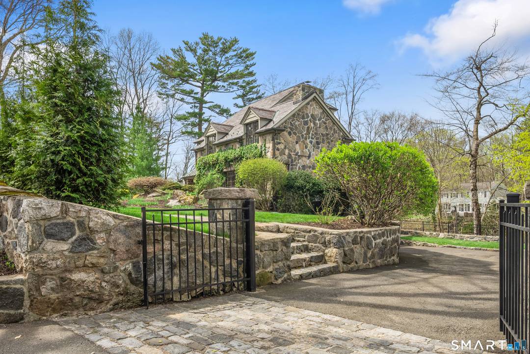 Set gracefully above the scenic Goodwives River, this exceptional 1930s stone residence blends timeless character with 3403sq ft of sophisticated modern updates.