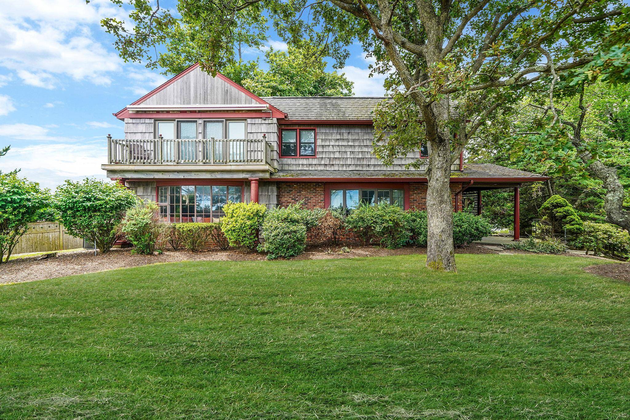 Discover your private beach retreat in this exceptional waterfront home perfectly positioned with shore to shore access between the Long Island Sound and Northport Bay.