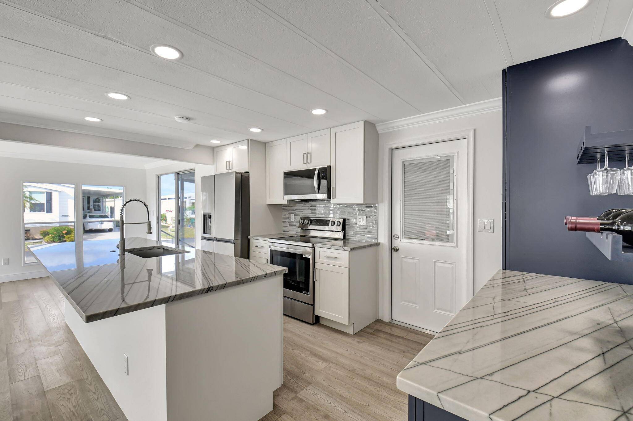 COMPLETELY REMODELED ! The PREMIERE property in all of Jamaica Bay, Boynton Beach's prime 55 manufactured home community !