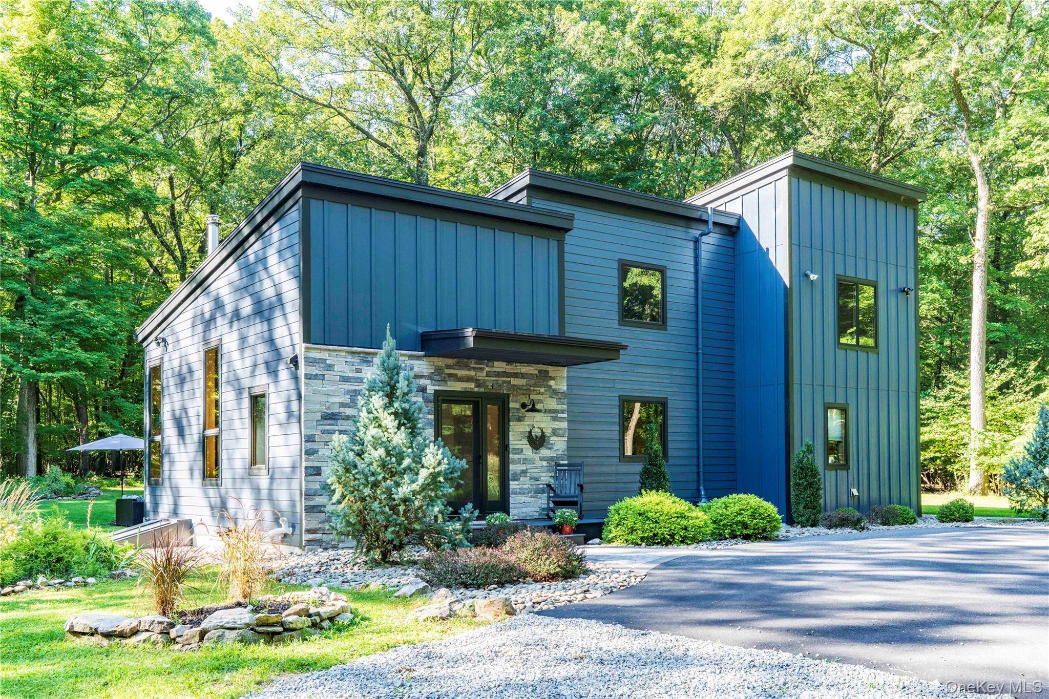 This architect designed country home is located at the end of Iron Mountain Road and bordered by Wawayanda State Park.
