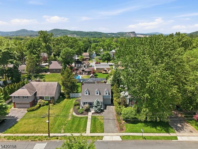 Great colonial cape with rocking chair front porch and fabulous in ground pool !