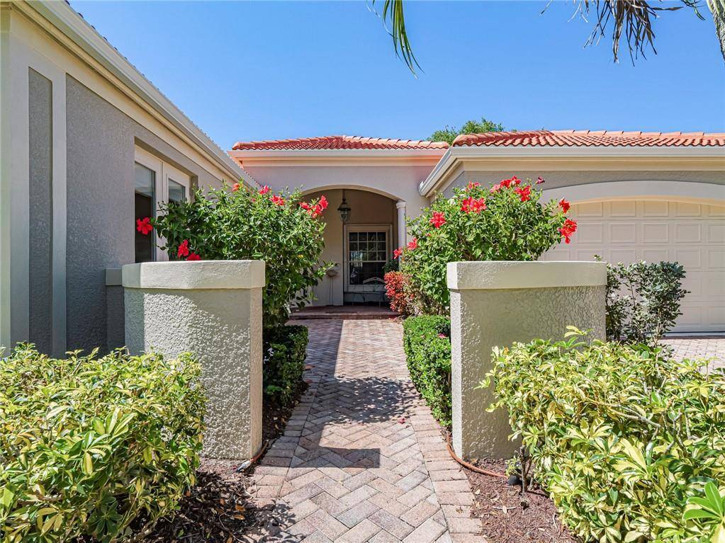 Welcome Home to this Former Model Home including brand new tile roof 2025, custom pool spa w brick paver surround, extended lanai overlooking serene lake, accordian storm shutters thruout.