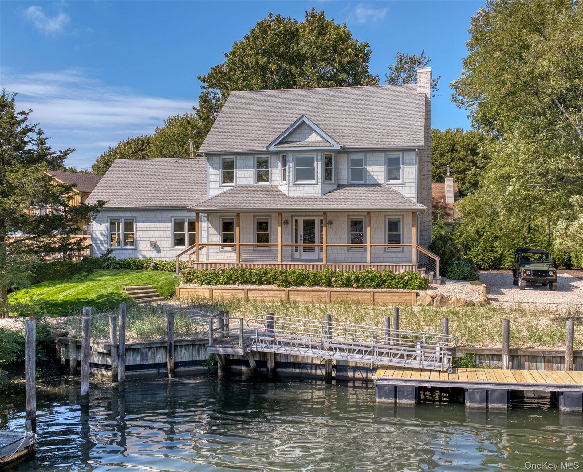 This beautifully renovated waterfront home house is not in a flood zone offers a seamless blend of modern comfort and timeless coastal style.