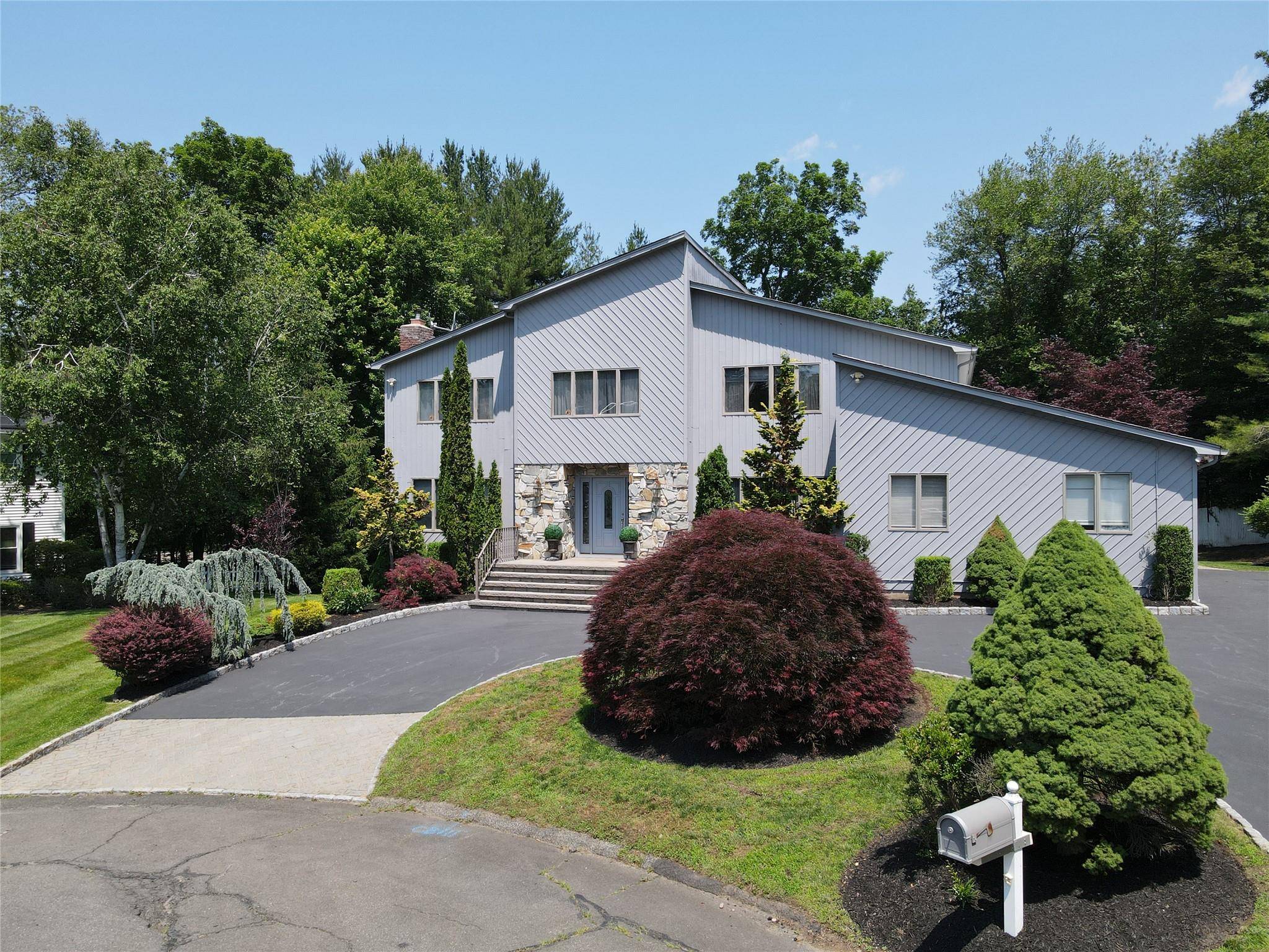 Welcome to this stunning contemporary center hall colonial located in a peaceful cul de sac within the highly sought after Clarkstown School District !