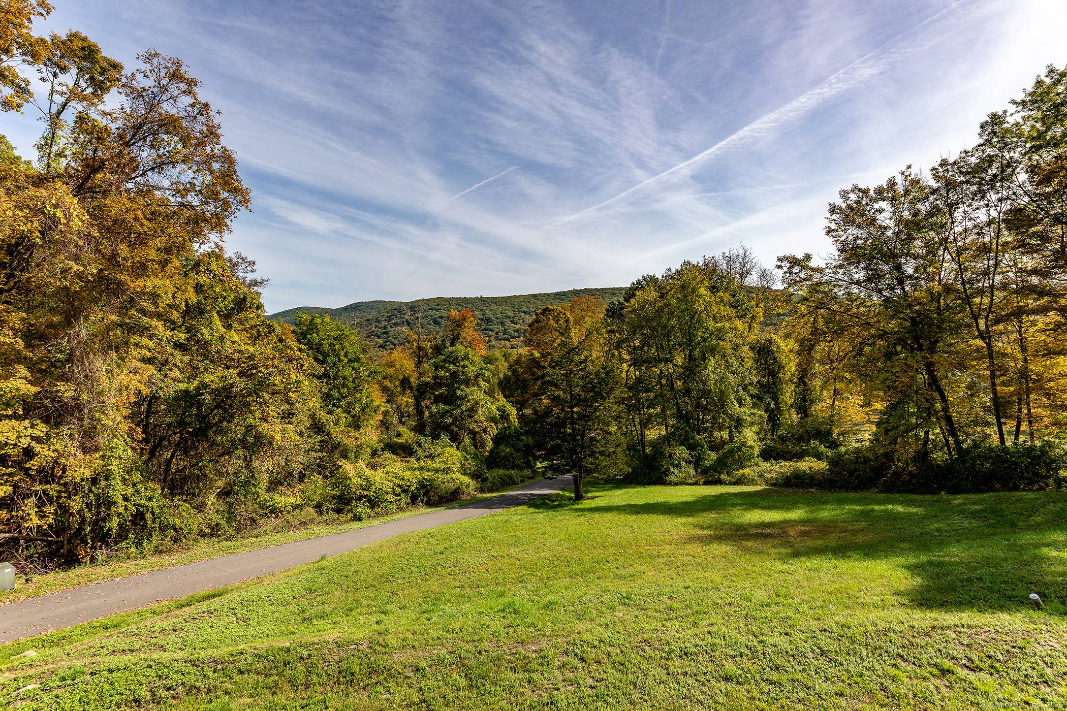 Escape to this mountaintop retreat with sweeping, unobstructed views located off one of the most desirable scenic roads in the Litchfield Hills.