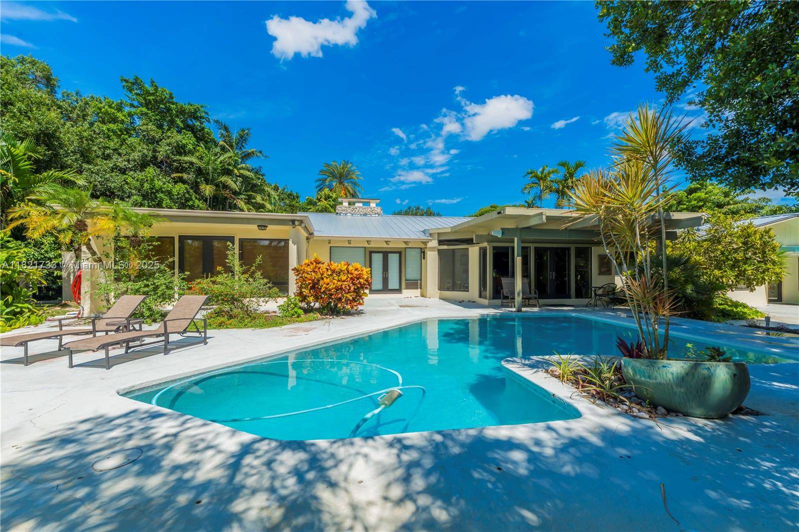 Experience serenity at the edge of the Everglades in this mid century modern masterpiece.