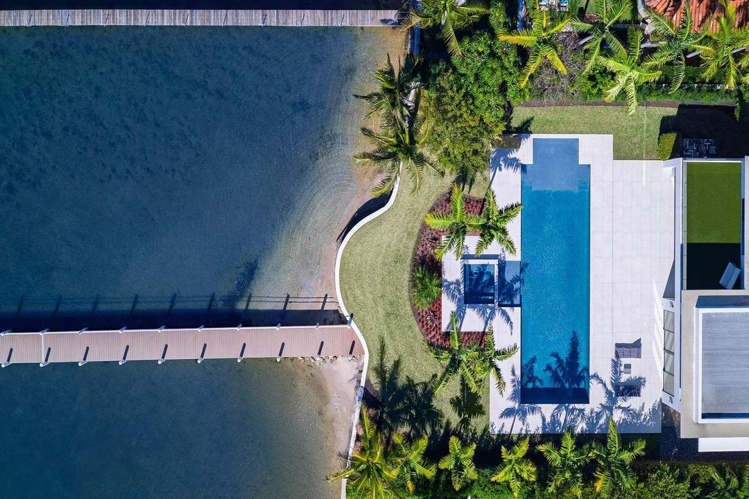Experience refined, effortless living in this gorgeous waterfront estate in the private enclave of Hypoluxo Island.