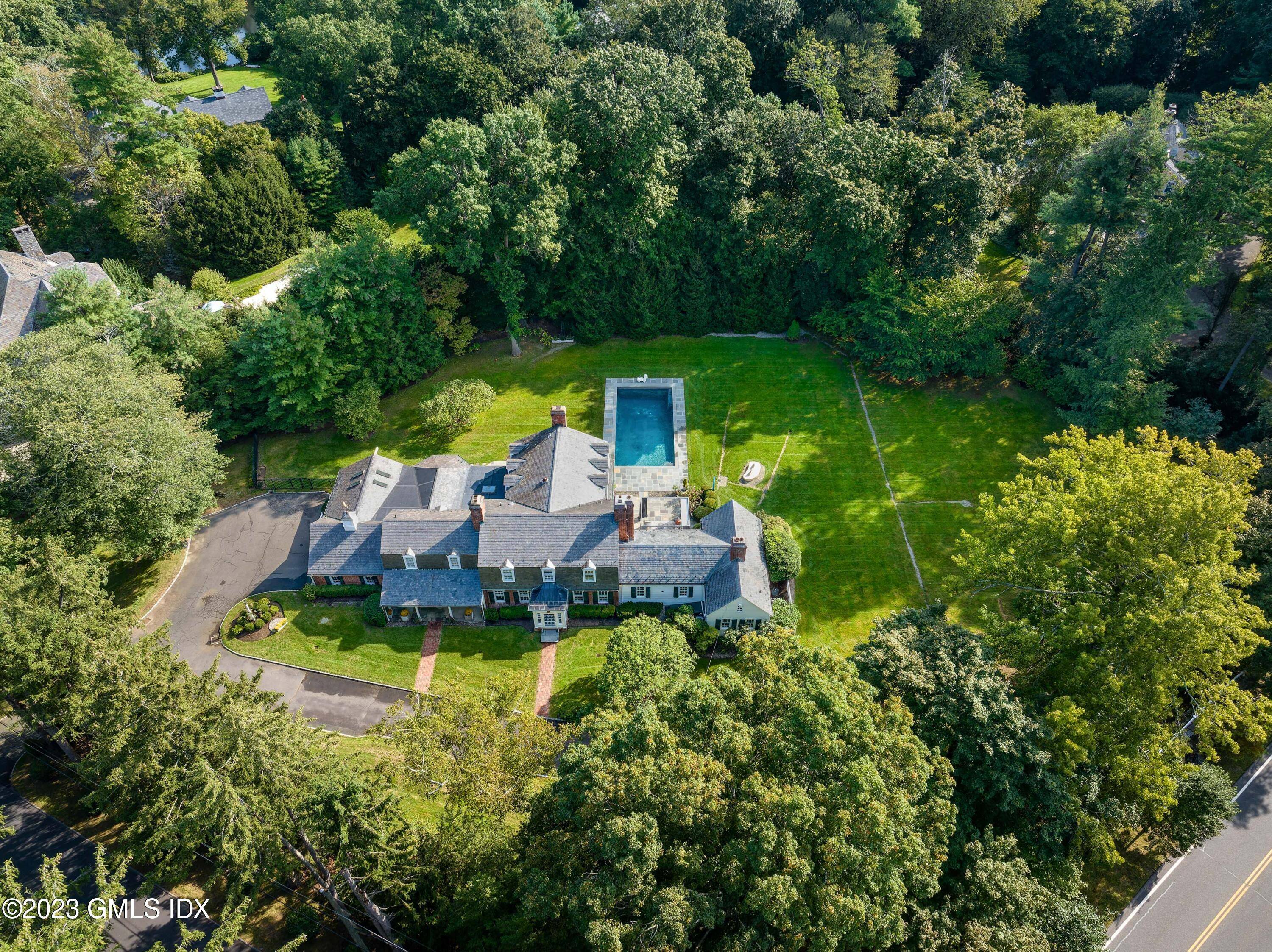Williamsburg style expanded and renovated six bedroom brick home showcases a new Signature pool and private, level fenced in backyard on a most desirable lane near town and schools.