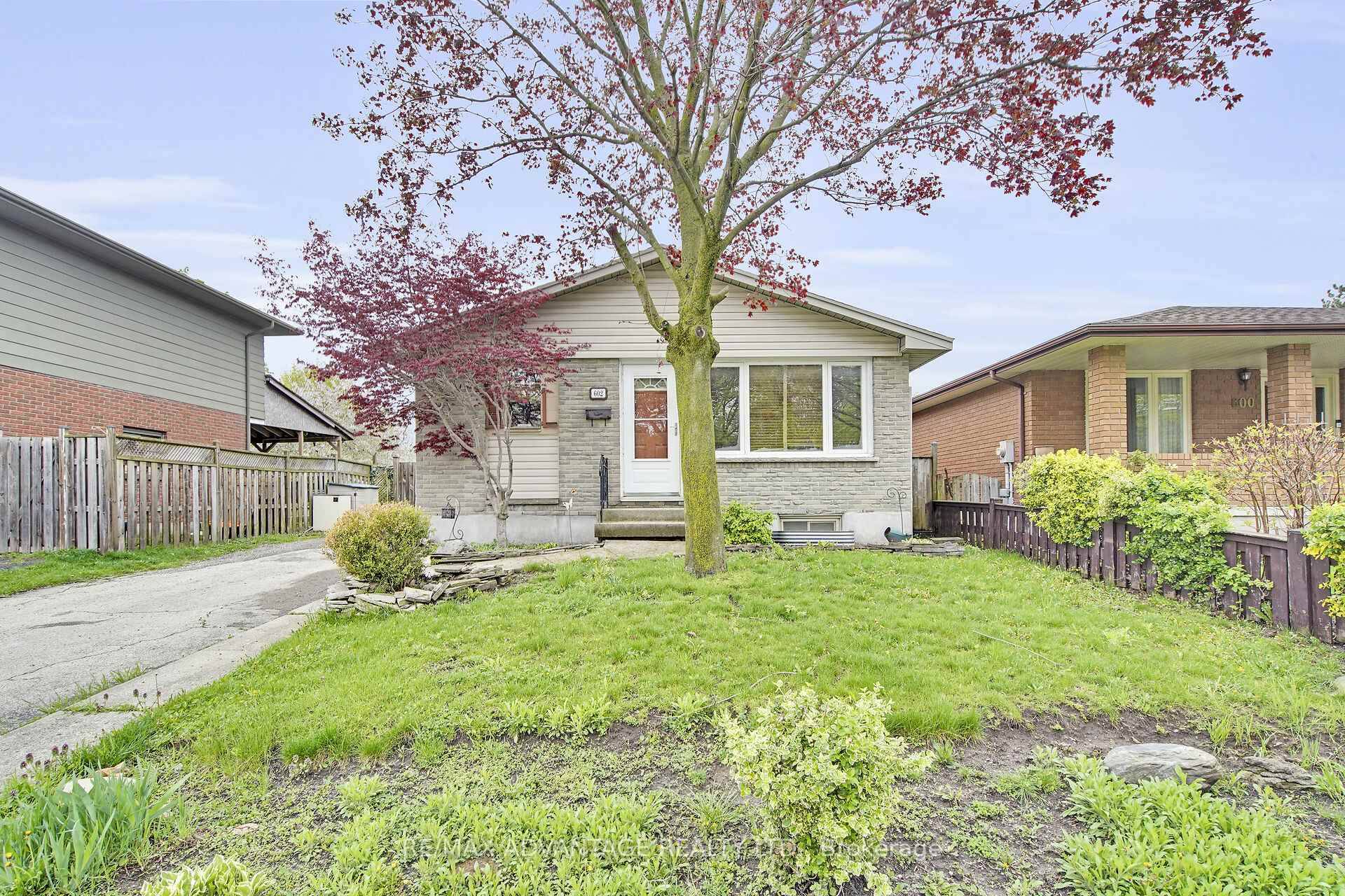 Spacious bungalow with a fantastic custom designed kitchen with built in oven, stove top, and kitchen island with breakfast bar.