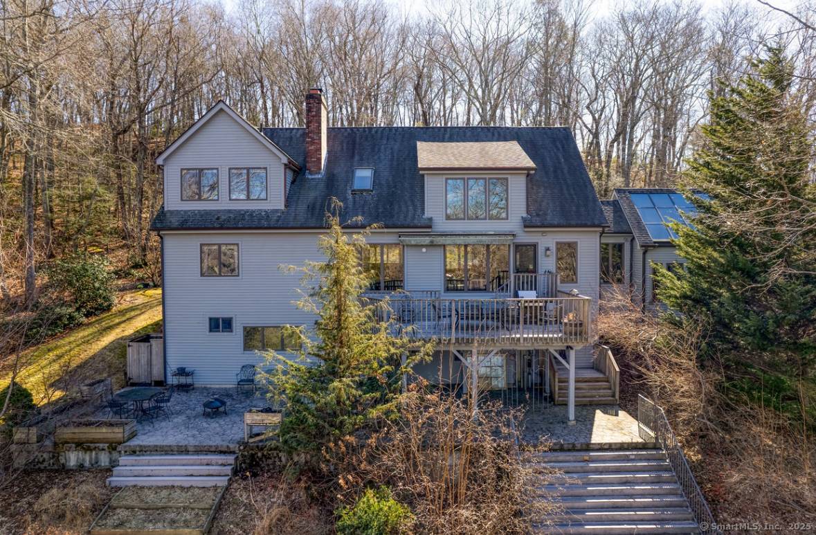 Perched on two acres of pristine lakefront property, this stunning home offers breathtaking tree top views of the water, surrounded by the tranquility of nature.