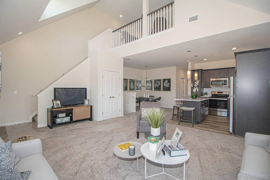 This stunning second floor unit features a modern open layout with quartz countertops, stainless steel appliances and a washer and dryer in unit.