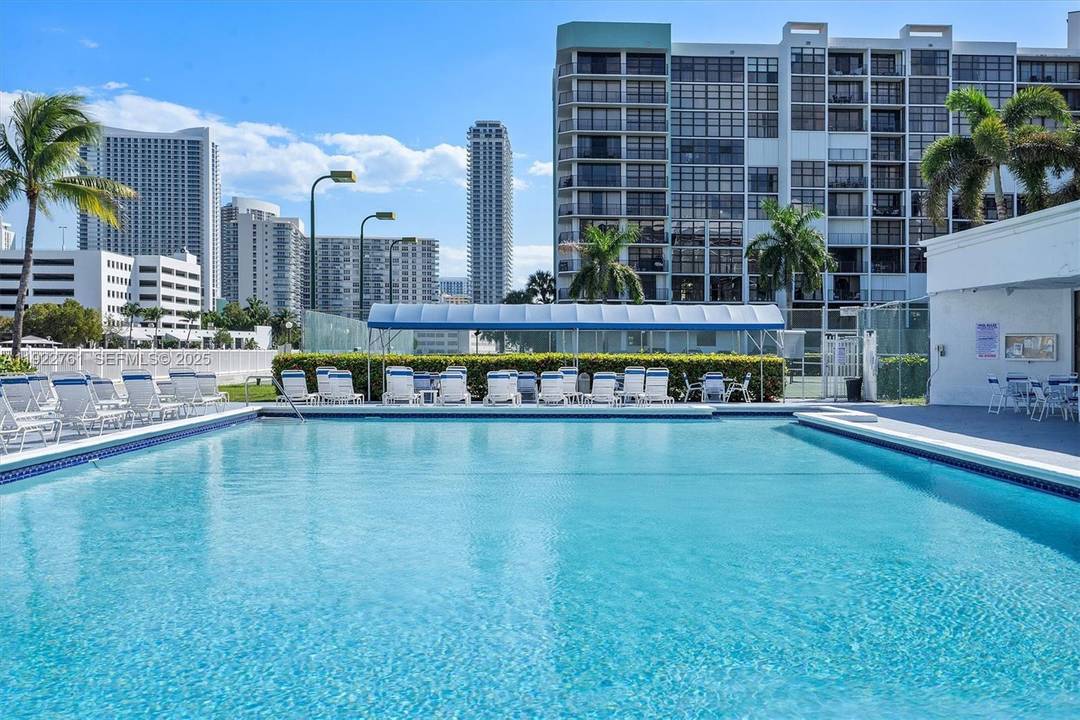Corner unit featuring floor to ceiling windows and wraparound balcony that showcase breathtaking views of the marina, city skyline, tennis courts, and spectacular sunsets.