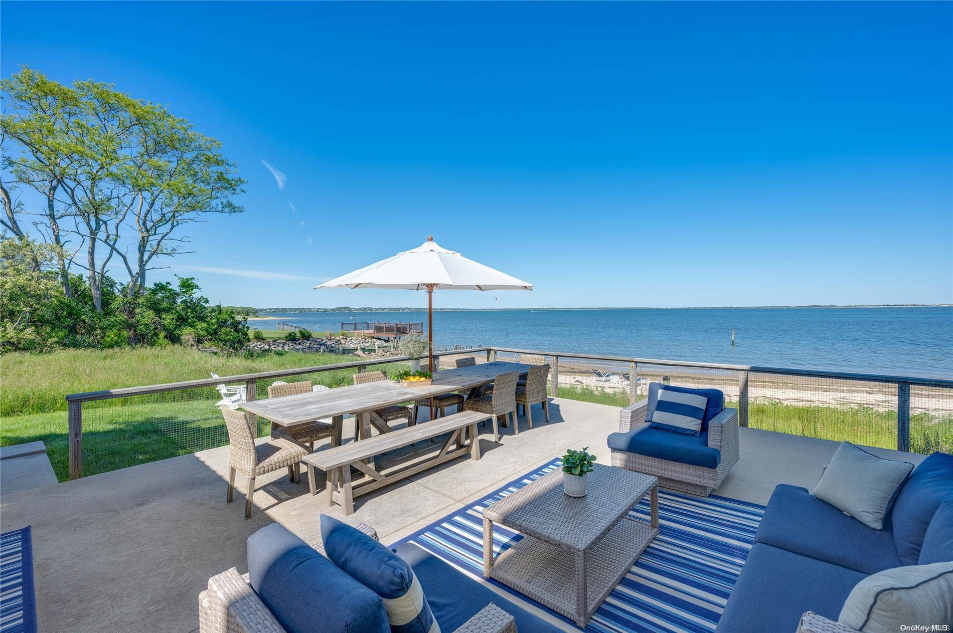 Spectacular Beachfront vacation home located directly on a private white sandy beach on Shinnecock Bay.