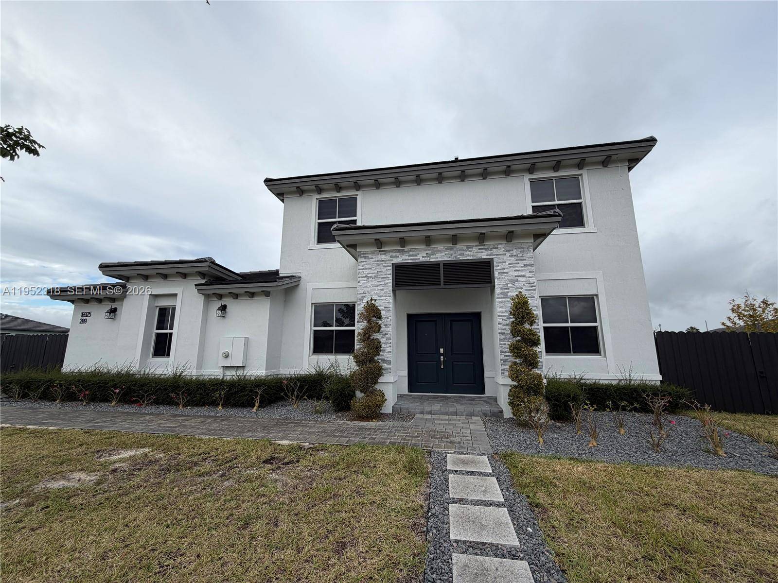 This spacious home features an open concept layout seamlessly connecting the living room, family room, dining area, and large kitchen.