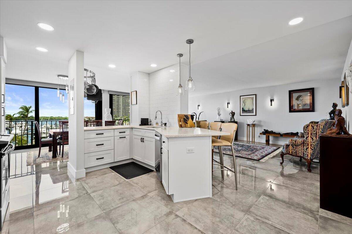 Step into sophisticated coastal living with this entirely renovated 2 bedroom, 2 bath residence in the highly desirable Old Port Cove community.