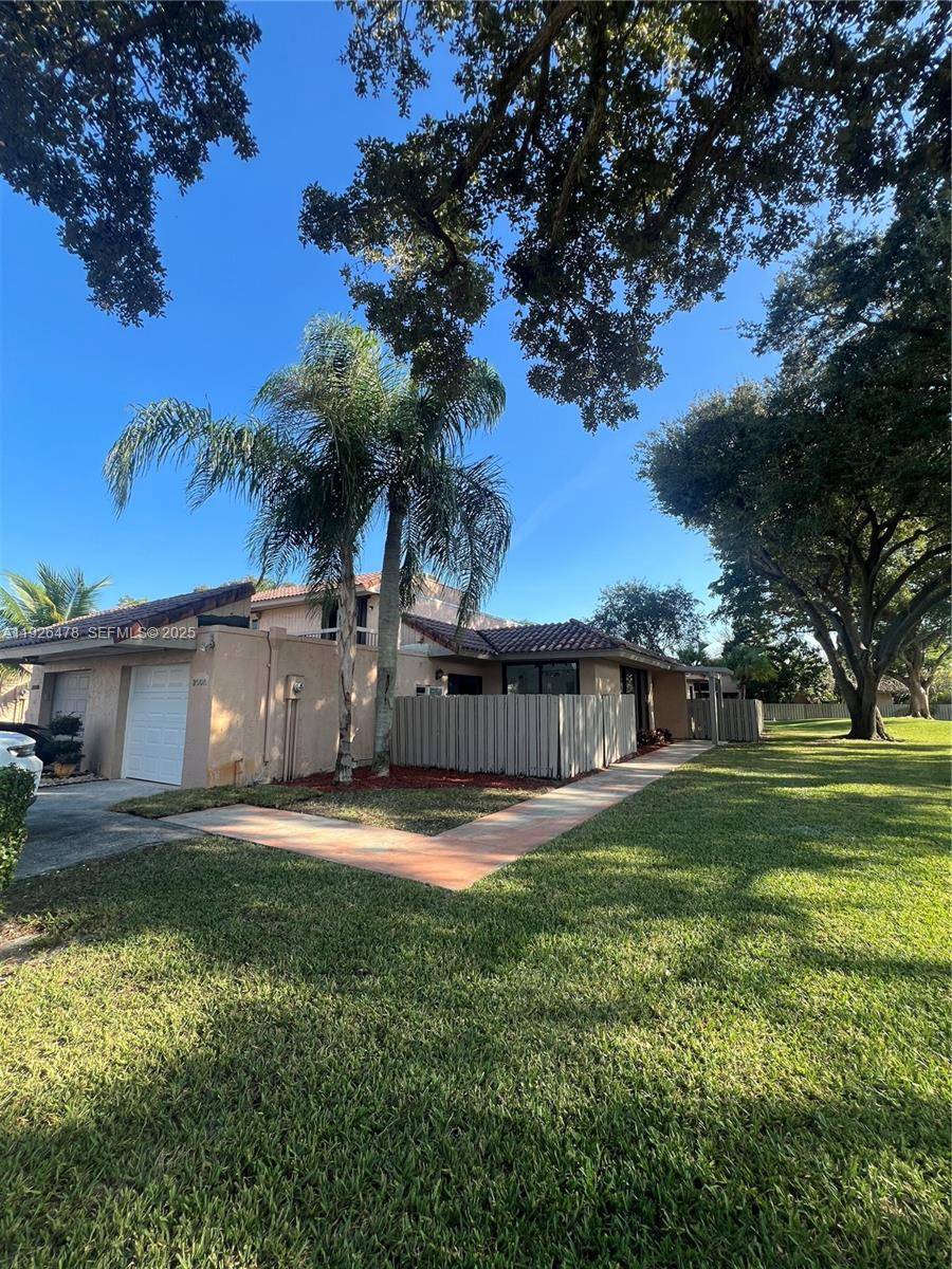 Discover modern elegance in this stunning, fully remodeled corner townhouse overlooking a tranquil garden setting and pool.