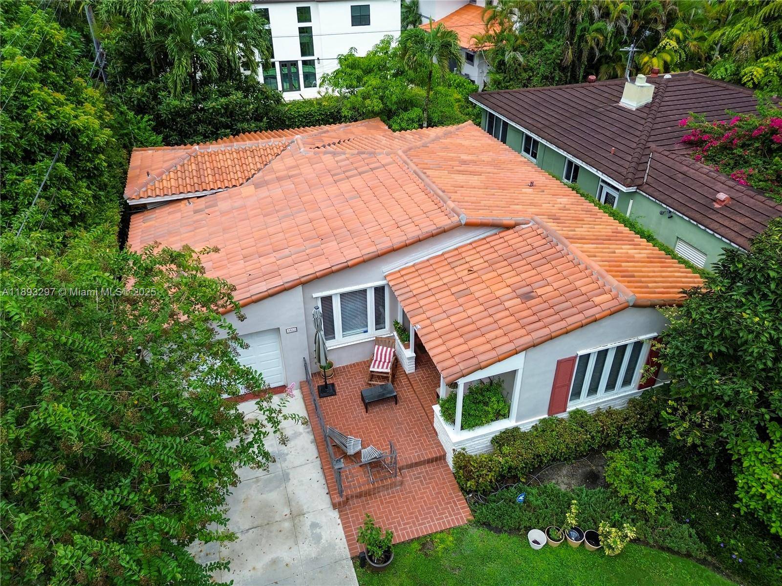 Welcome to an elegant sanctuary nestled beneath the majestic tree canopies of Coral Gables.