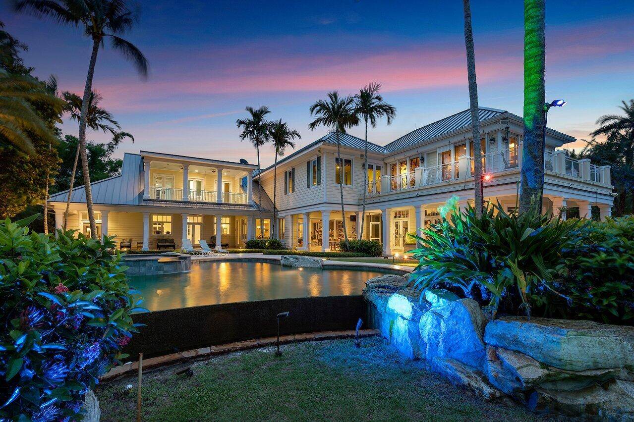 Key West style estate situated on the Loxahatchee River in Jupiter's premier neighborhood, Pennock Point.