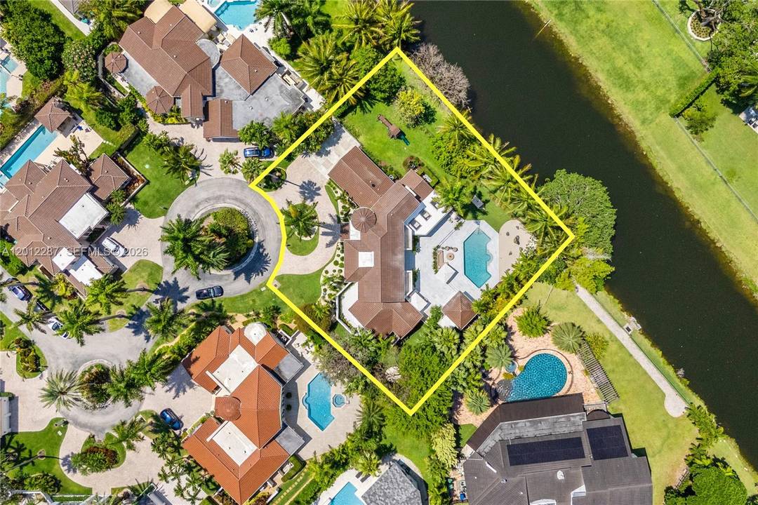Tucked behind the gates of an exclusive enclave of just 12 residences, this two story Mediterranean villa offers the rare combination of privacy, serenity, and an unbeatable North Pinecrest location.