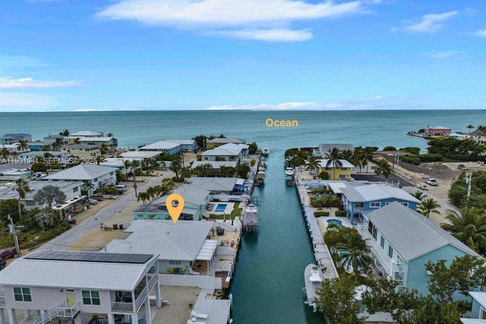 Step out to your private 35 ft dock on a clean, deep canal with quick ocean access from this solid CBS half duplex.