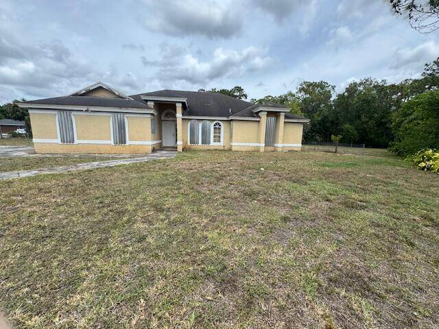 This 4 bedroom, 2 bath home sits on a generous 1.