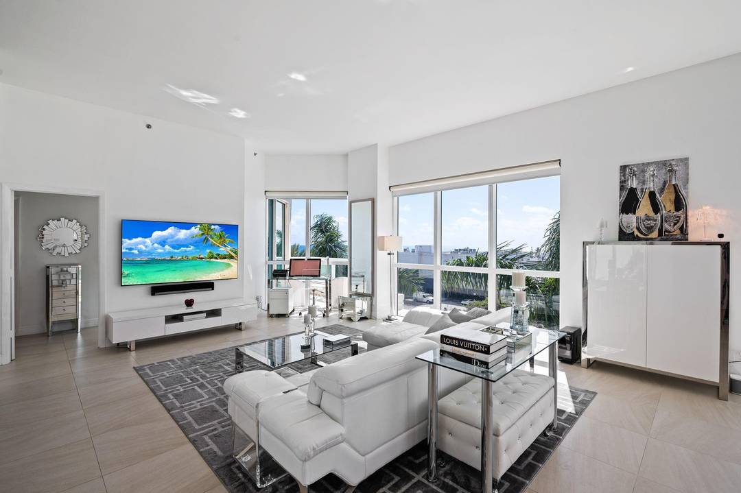 Exceptional southwest corner residence at the iconic Beach Club offering panoramic ocean, Intracoastal, and city views from sunrise to sunset.