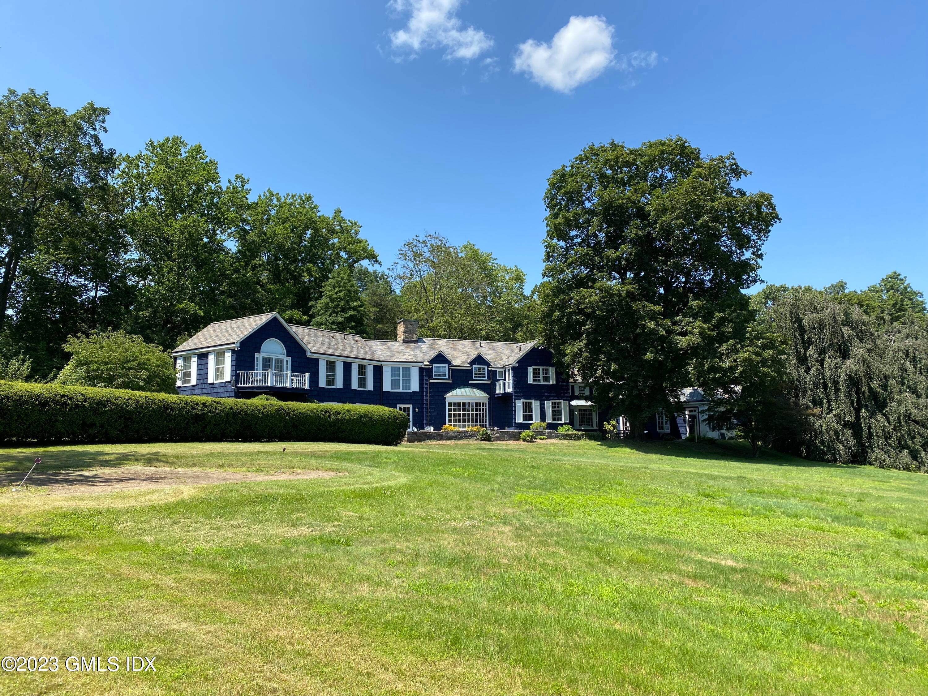 Expansive private estate of extraordinary dimension, encompassing more than seven beautiful acres, with pool, and separate one bedroom cottage, north and east bordering more than 100 acres of wildflowers sanctuaries.