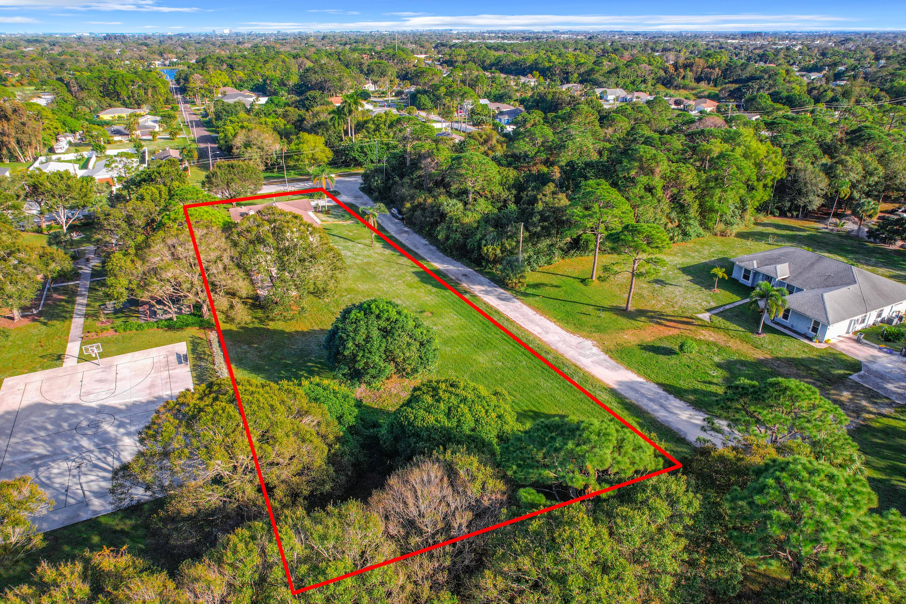Exceptional investor opportunity on nearly an acre corner lot in Jupiter's coveted school district.
