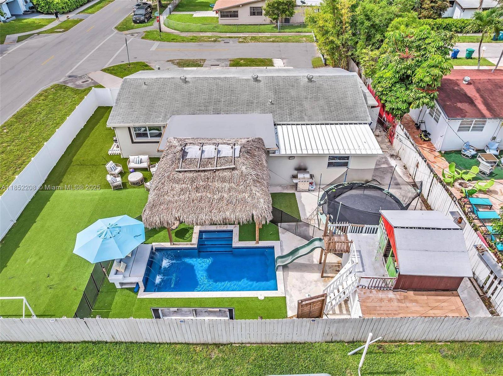 Beautifully renovated 4BR 2BA corner lot home with private theater, resort style pool, gazebo, and play area.