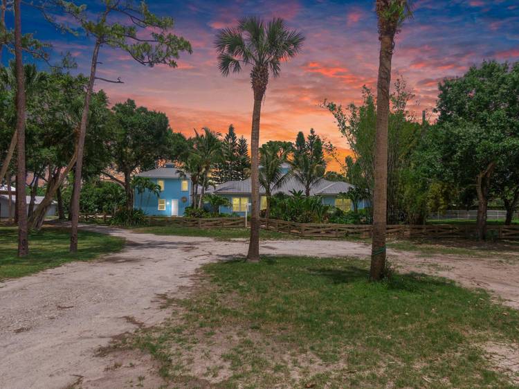 Live where you can ride, relax, and entertain on this rare 3 acre equestrian estate in Stuart.