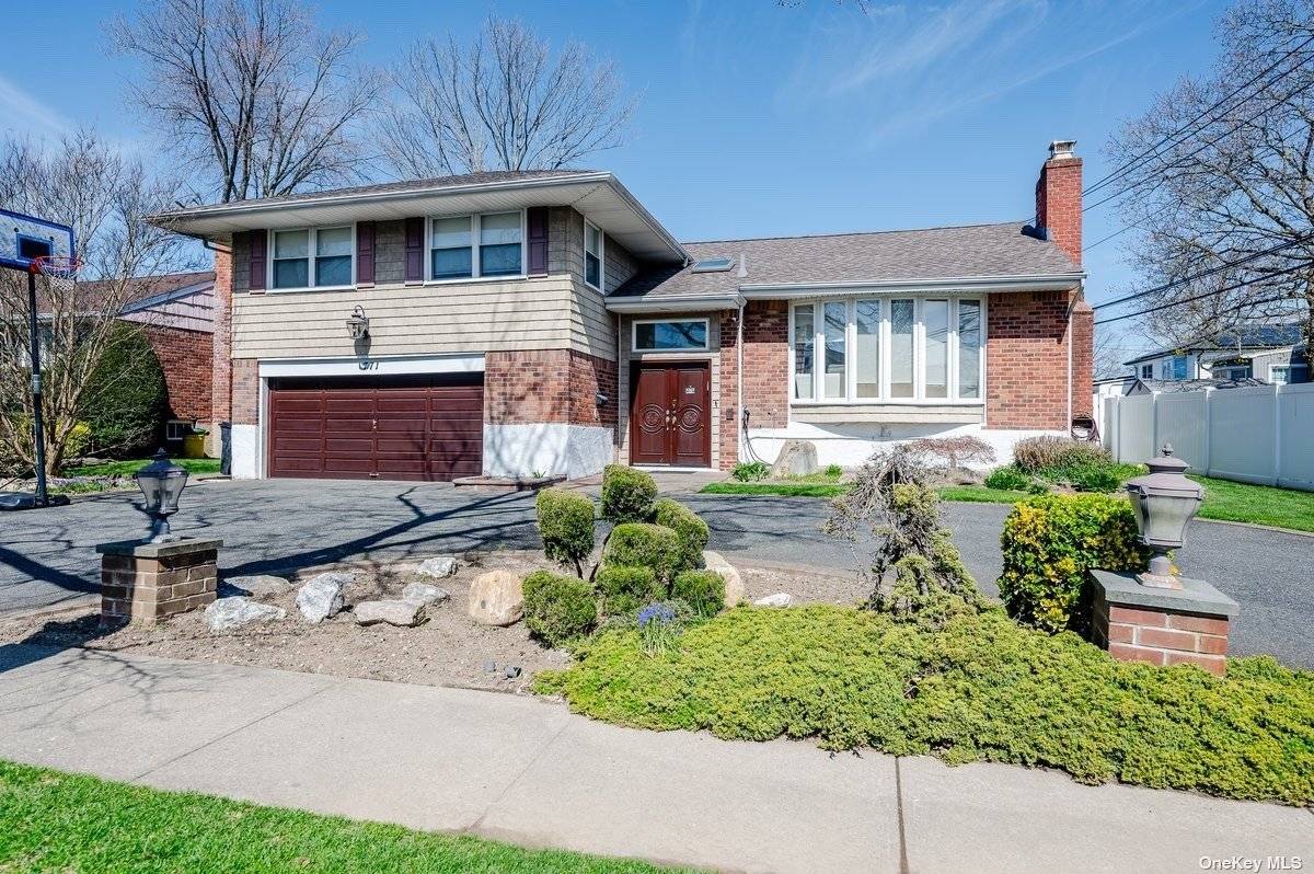 Nestled on one of North Woodmere's most coveted blocks, this 4 bedroom, 3.