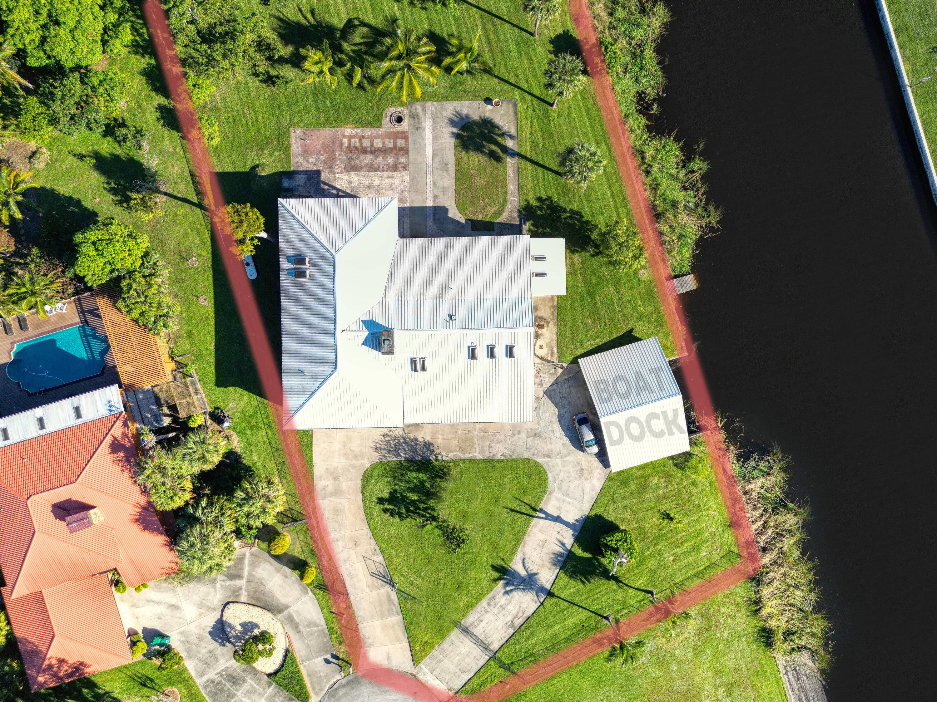 Escape to your own tropical retreat with this expansive 5, 000 sq ft gated home, perfectly situated on a stunning 1 acre corner canal lot.