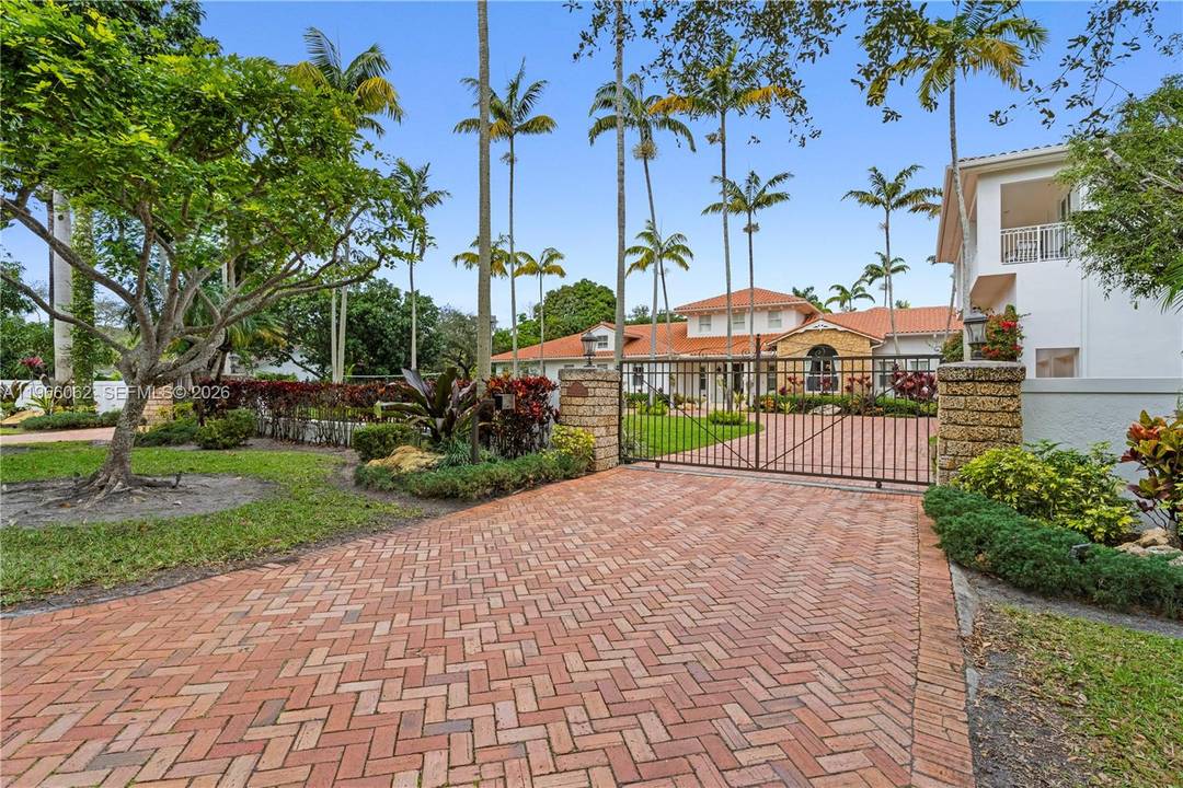 Set on a gated full acre in the heart of Pinecrest, this elegant 6 bedroom, 7 bath estate blends modern upgrades with timeless design, offering exceptional privacy, scale, and seamless ...