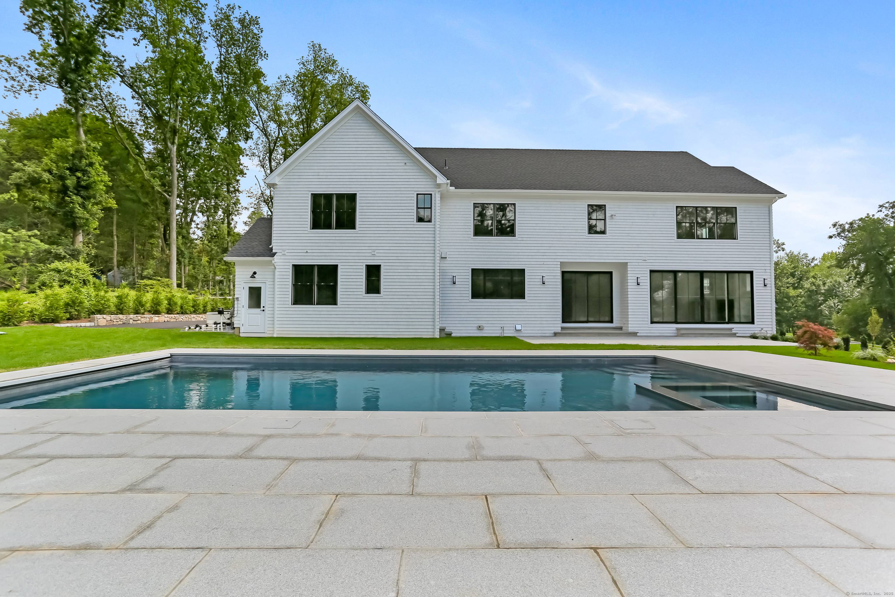 This is the second of 2 custom homes in final stages of completion, beautifully sited at the end of a private lane in the heart of Greens Farms.