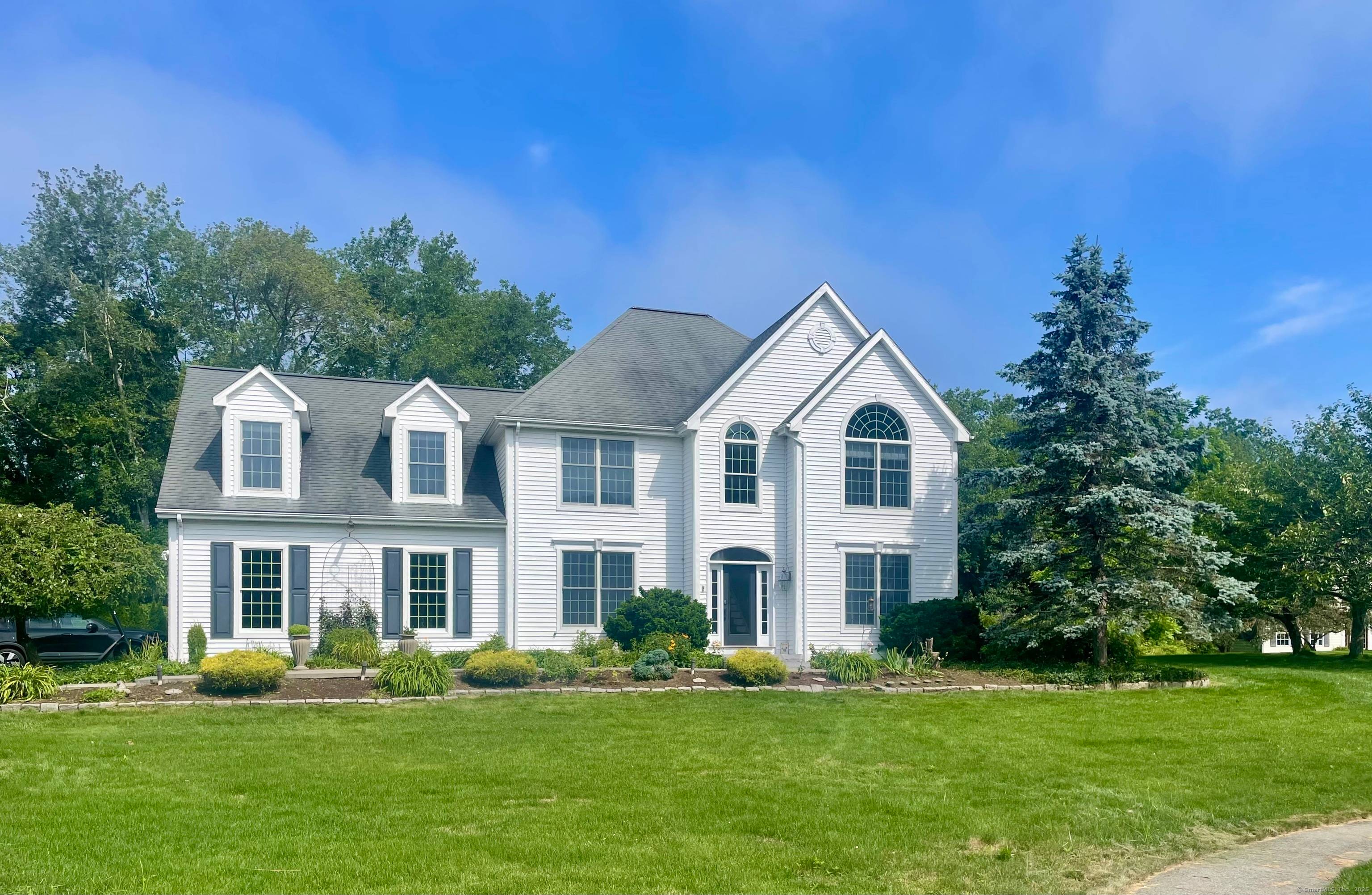 Welcome to this elegant and expansive Colonial home where modern comfort meets serene natural beauty.