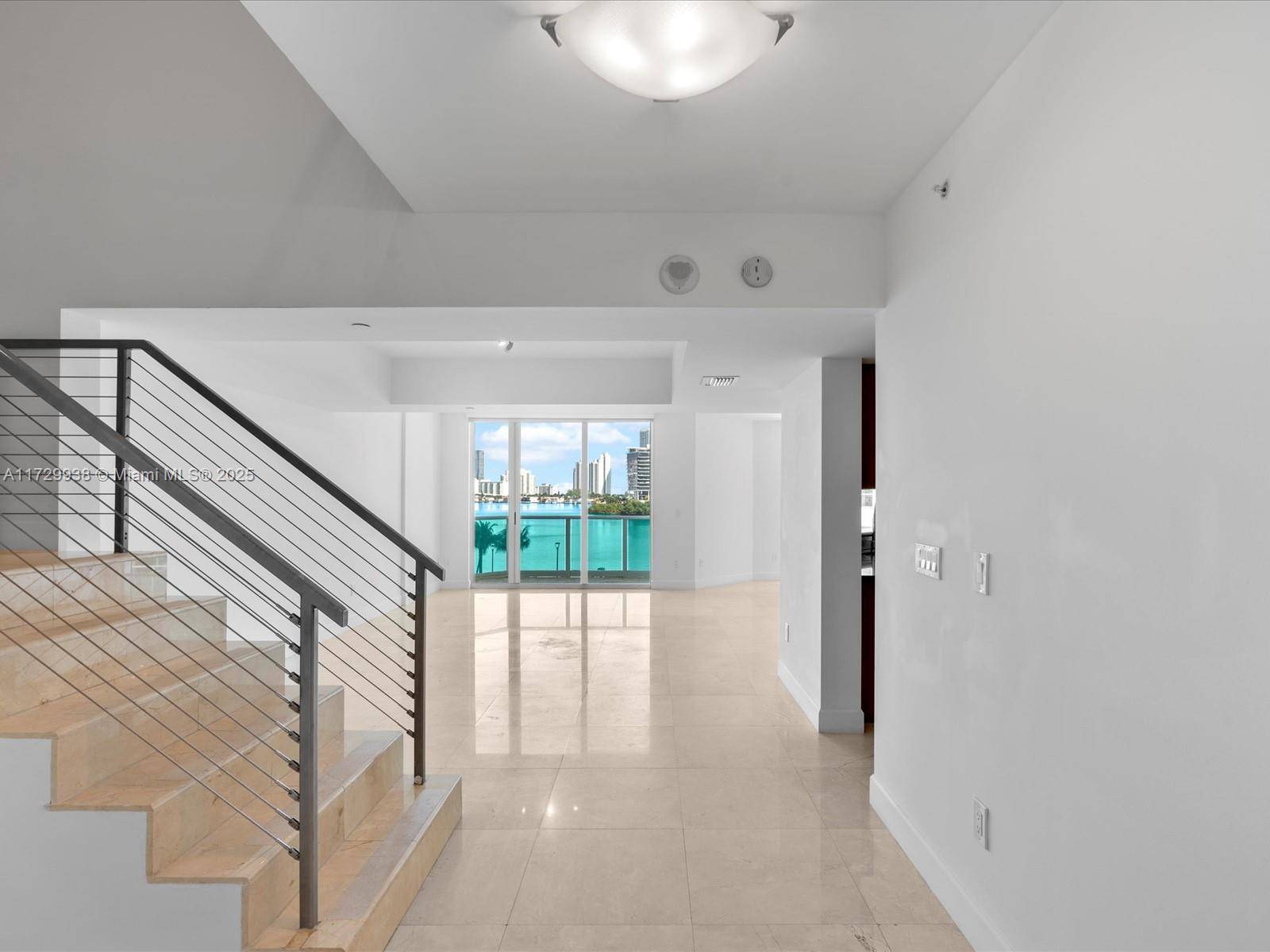 Experience luxury living in this spacious two story condo at the prestigious Peninsula II.